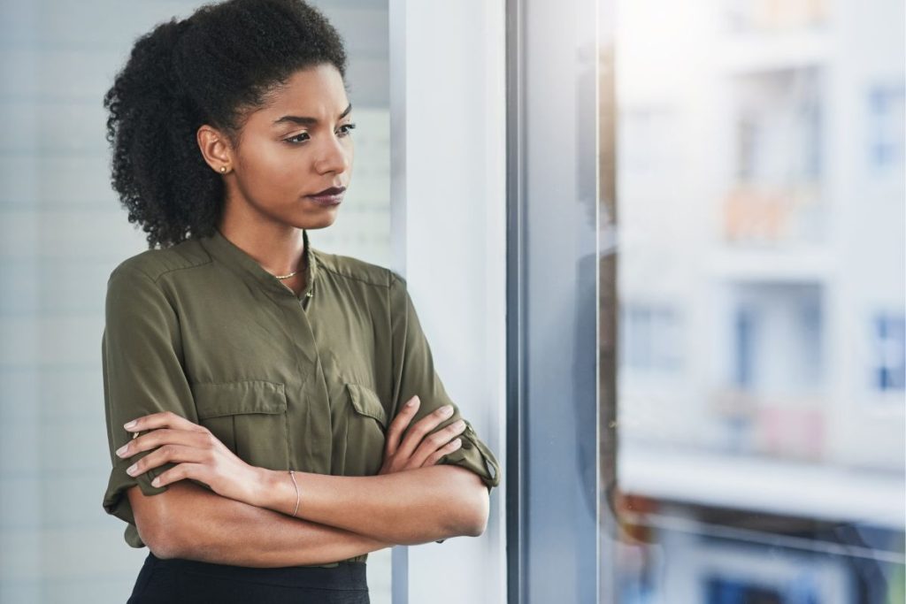 Woman looking out of a window at work
